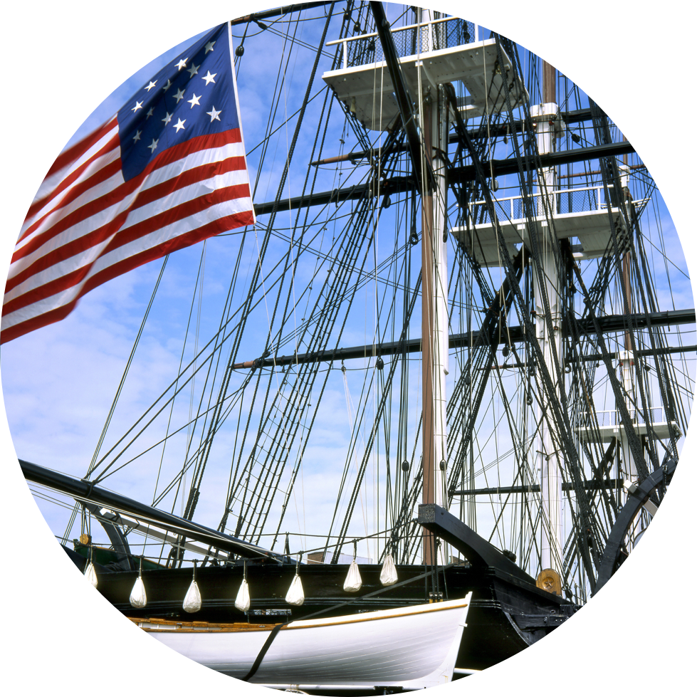 Image of USS Constitution's masts and large USA flag flying