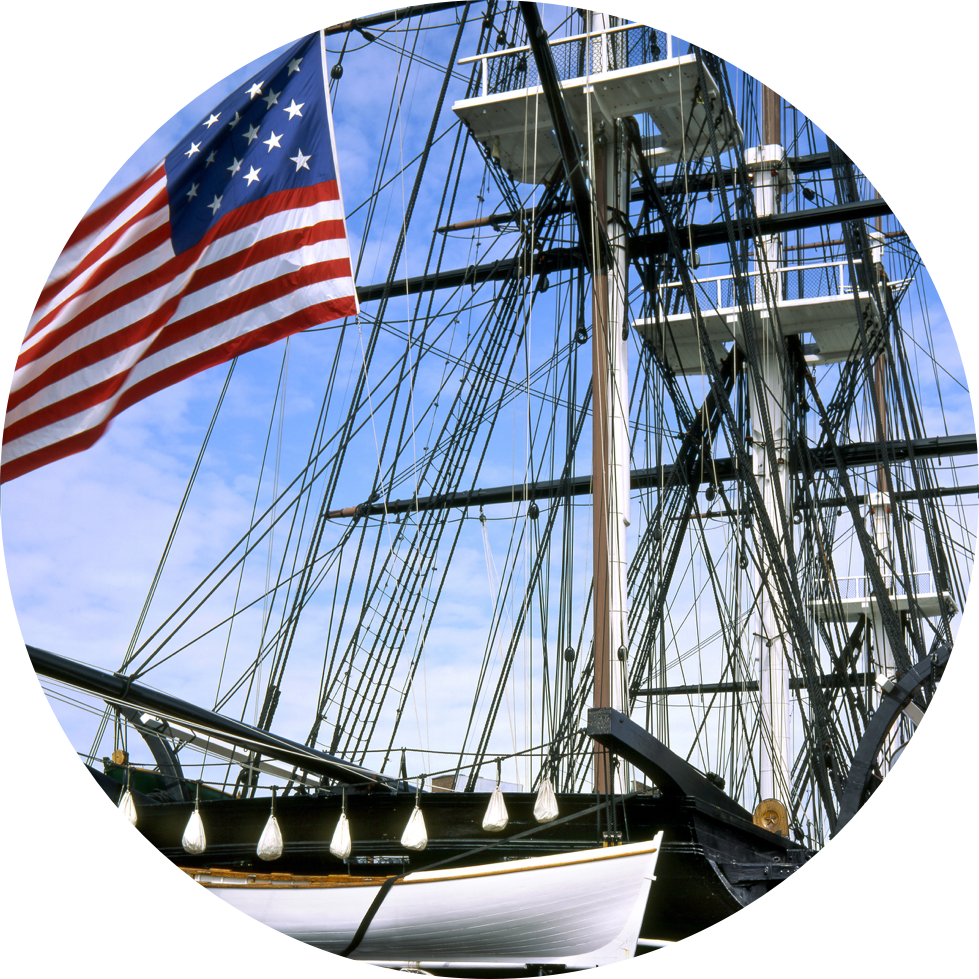 Image of USS Constitution's masts and large USA flag flying