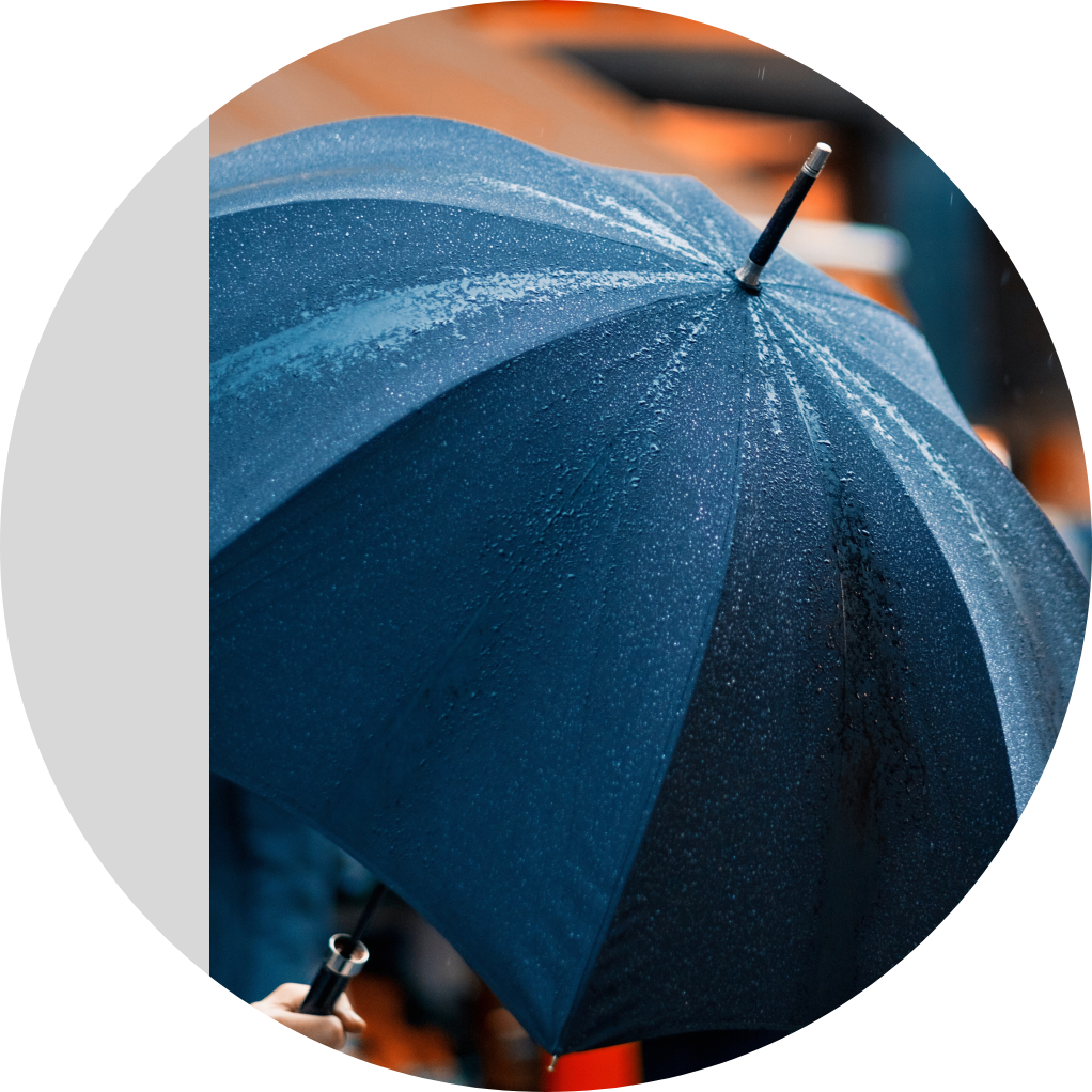 Image of a navy blue umbrella in the rain