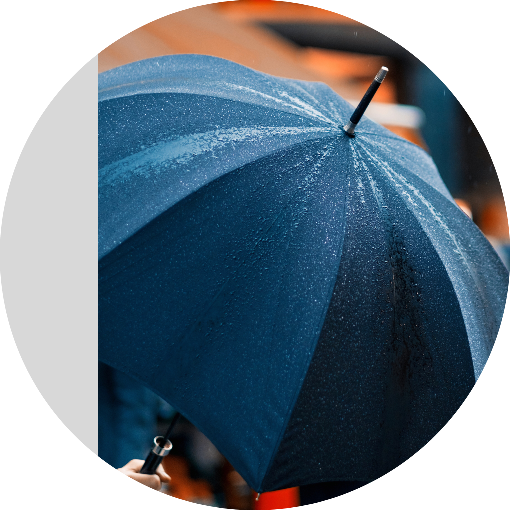 Image of a navy blue umbrella in the rain