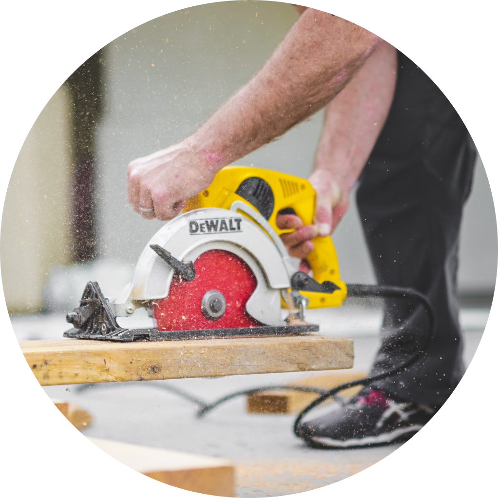 Image of person sawing wood with power tools